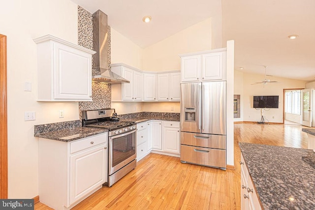 29 Salt Grass Rd, Ocean Pines, MD 21811 - kitchen featuring appliances with stainless steel finishes, wall chimney exhaust hood, light wood-style floors, white cabinetry, and high vaulted ceiling