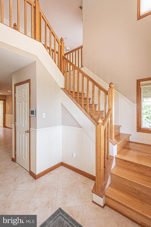29 Salt Grass Rd, Ocean Pines, MD 21811 - stairway featuring wainscoting and tile patterned flooring