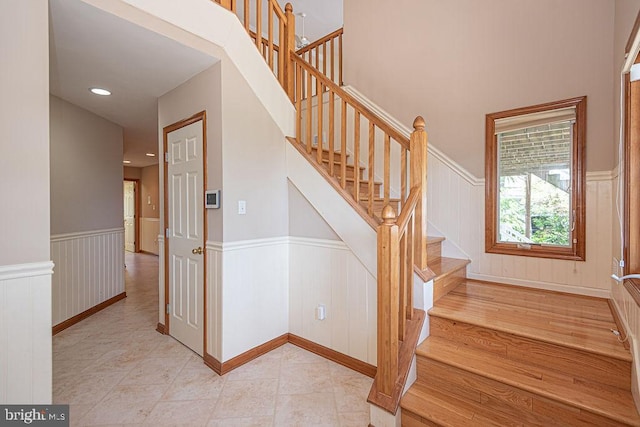 29 Salt Grass Rd, Ocean Pines, MD 21811 - staircase with wainscoting, tile patterned flooring, and a decorative wall