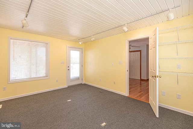 29 Salt Grass Rd, Ocean Pines, MD 21811 - unfurnished room with track lighting, dark colored carpet, baseboards, and wooden ceiling