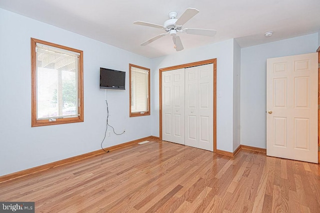 29 Salt Grass Rd, Ocean Pines, MD 21811 - unfurnished bedroom with light wood-type flooring, baseboards, a closet, and a ceiling fan