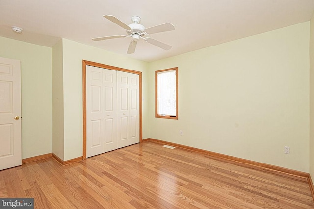 29 Salt Grass Rd, Ocean Pines, MD 21811 - unfurnished bedroom with baseboards, light wood-style flooring, a closet, and a ceiling fan