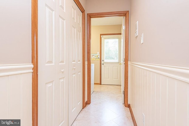 29 Salt Grass Rd, Ocean Pines, MD 21811 - hallway with a decorative wall, a wainscoted wall, and light tile patterned floors