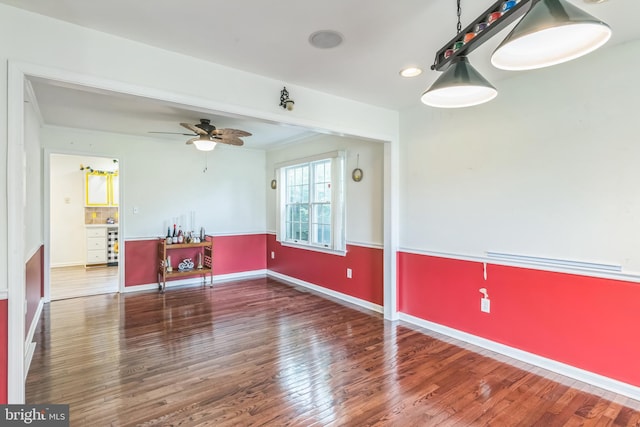 unfurnished living room with baseboards, recessed lighting, wood finished floors, ceiling fan, and beverage cooler