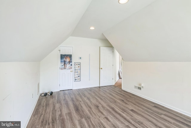 bonus room featuring recessed lighting, lofted ceiling, wood finished floors, visible vents, and baseboards