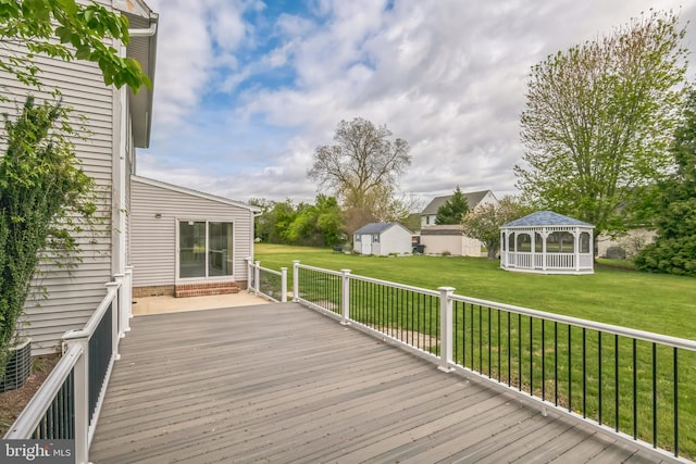 deck featuring a gazebo and a lawn