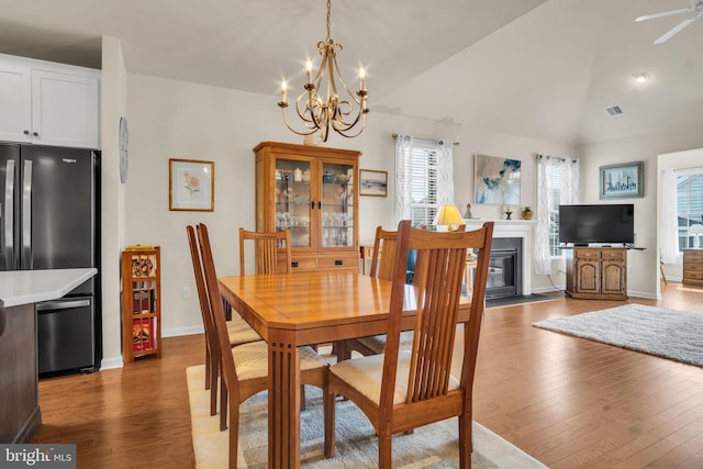 323 Valor Dr, Mechanicsburg, PA 17050 - dining space with baseboards, lofted ceiling, wood finished floors, and a wealth of natural light