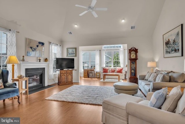 323 Valor Dr, Mechanicsburg, PA 17050 - living area with a fireplace with flush hearth, high vaulted ceiling, ceiling fan, and visible vents