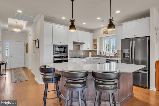 323 Valor Dr, Mechanicsburg, PA 17050 - kitchen with visible vents, under cabinet range hood, appliances with stainless steel finishes, and backsplash