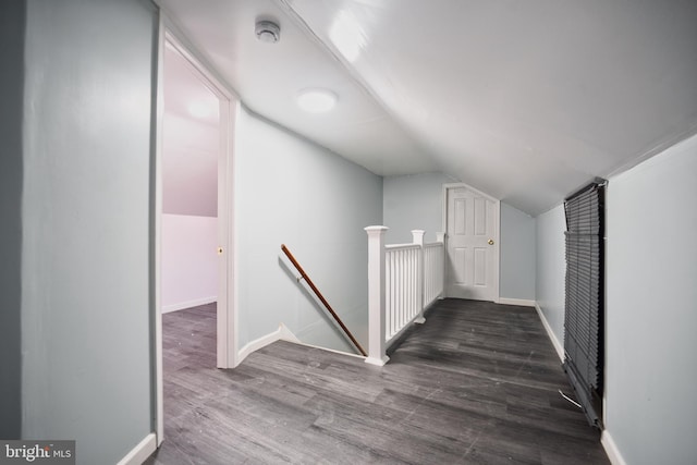 bonus room with wood finished floors, baseboards, and lofted ceiling