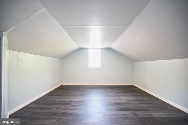 bonus room with baseboards, vaulted ceiling, and wood finished floors