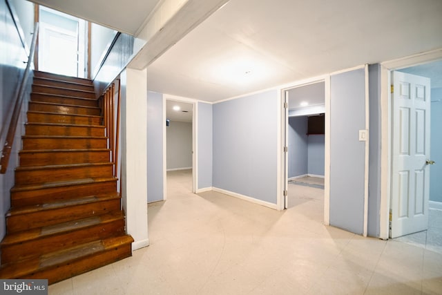 stairway with baseboards and tile patterned floors