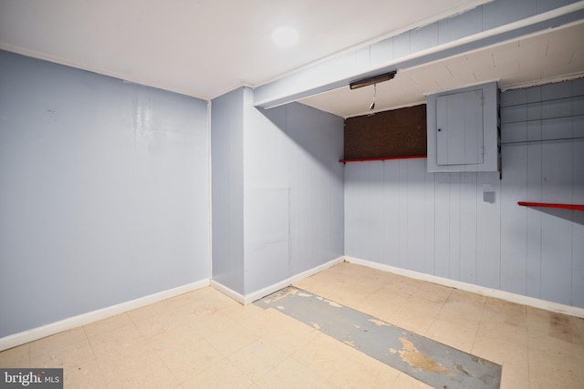 finished below grade area featuring baseboards and tile patterned floors