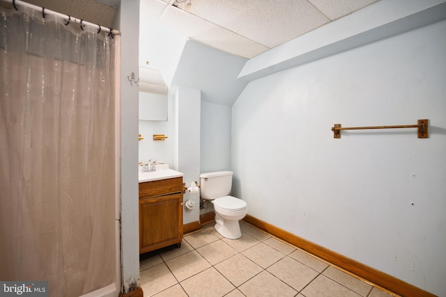 bathroom with vanity, toilet, tile patterned floors, a shower with shower curtain, and baseboards