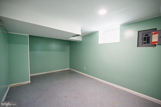 below grade area featuring baseboards and electric panel