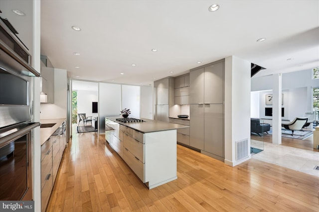 kitchen featuring gray cabinetry, appliances with stainless steel finishes, modern cabinets, and visible vents