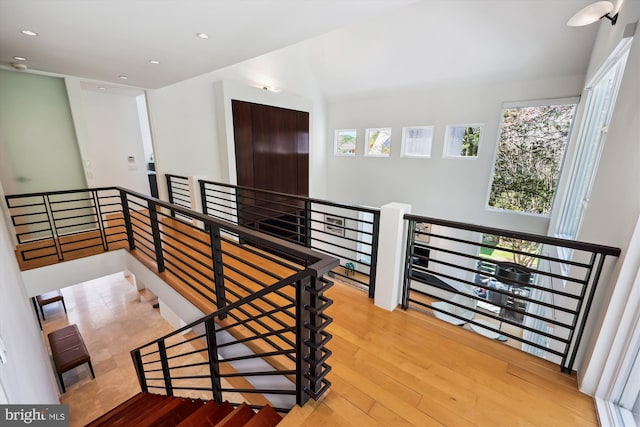stairway with recessed lighting and wood finished floors