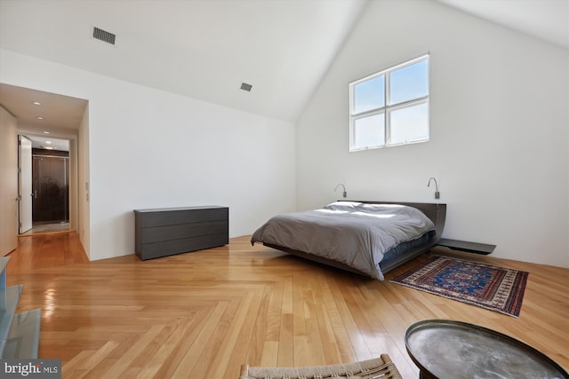 bedroom featuring visible vents and high vaulted ceiling