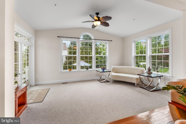 sitting room featuring healthy amount of natural light, vaulted ceiling, ceiling fan, and baseboards