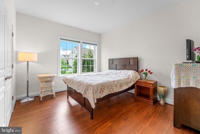 bedroom featuring wood finished floors and baseboards