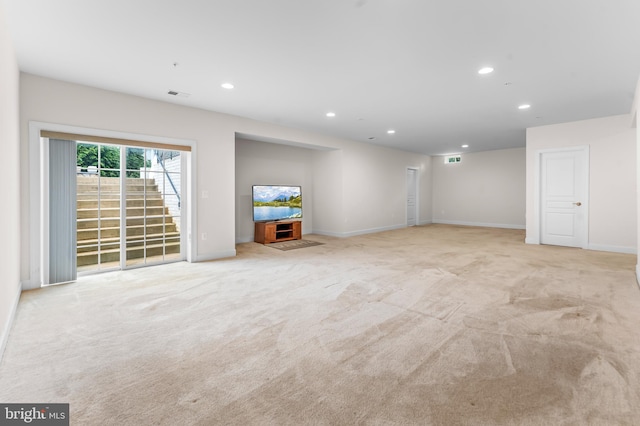 unfurnished living room with recessed lighting, carpet, and baseboards