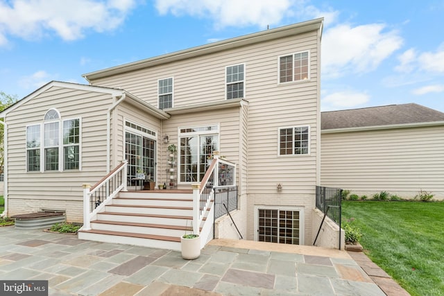 rear view of house with a yard