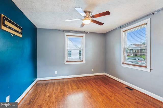 5218 Arbutus Ave, Baltimore, MD 21227 - empty room with wood finished floors, baseboards, ceiling fan, and a textured ceiling