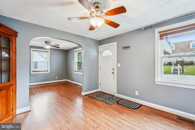 5218 Arbutus Ave, Baltimore, MD 21227 - entryway with arched walkways, ceiling fan, wood finished floors, and baseboards