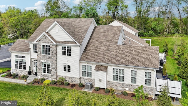 207 Reid Way, West Chester, PA 19382 - rear view of property with a lawn, central AC unit, a shingled roof, and stone siding