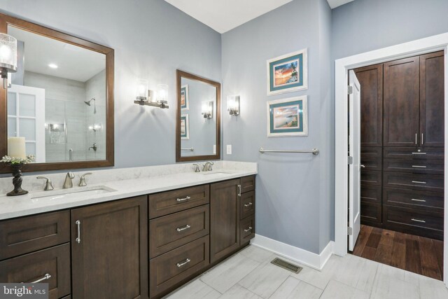 207 Reid Way, West Chester, PA 19382 - bathroom featuring baseboards, visible vents, a sink, and a stall shower