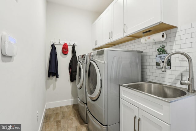 207 Reid Way, West Chester, PA 19382 - laundry room featuring separate washer and dryer, a sink, cabinet space, and baseboards