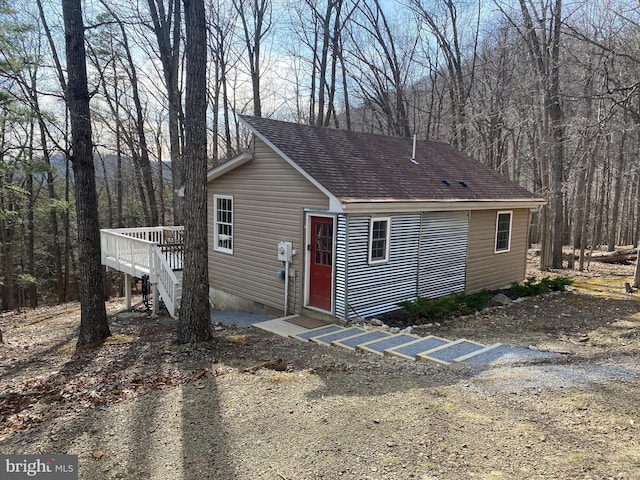 659 Settlers Valley Way, Lost River, WV 26810 - view of front of property with stairs, a shingled roof, a deck, crawl space, and a forest view