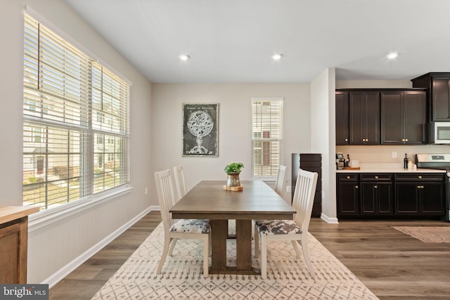 dining room with recessed lighting, dark wood finished floors, and baseboards