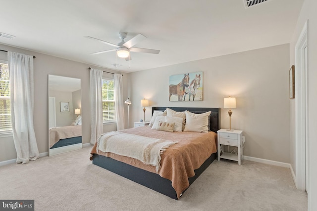 bedroom featuring baseboards, light carpet, and visible vents
