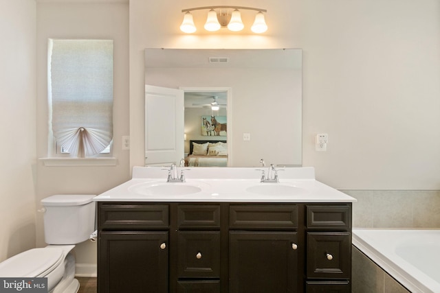 ensuite bathroom with a sink, toilet, double vanity, and visible vents