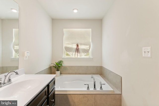 bathroom with vanity and a bath
