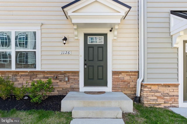 entrance to property with stone siding