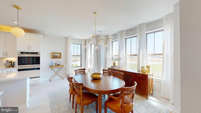 dining area with baseboards and light wood-type flooring