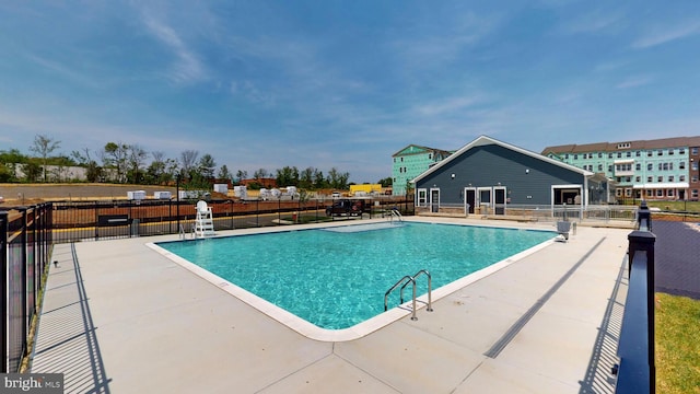 pool with fence and a patio area