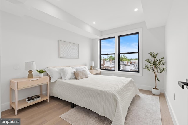 bedroom with light wood-style flooring, baseboards, and recessed lighting