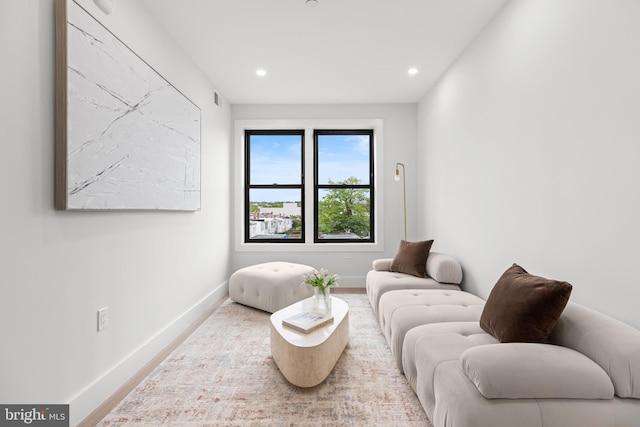 sitting room featuring baseboards, recessed lighting, and wood finished floors