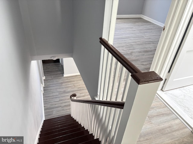 stairs featuring baseboards and wood finished floors