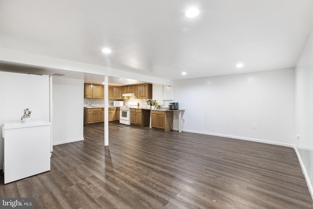 unfurnished living room with recessed lighting, baseboards, and dark wood-style floors