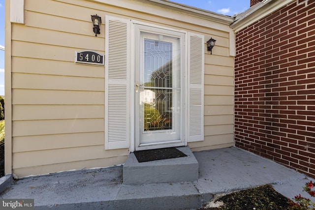 entrance to property with brick siding