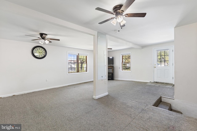 unfurnished living room with baseboards, a ceiling fan, and carpet flooring