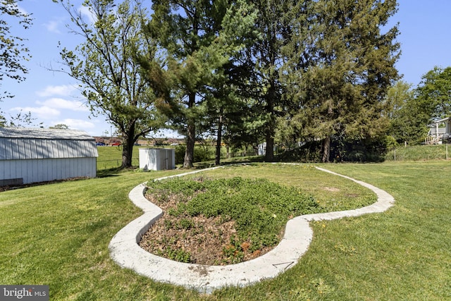 view of yard featuring an outdoor structure and fence