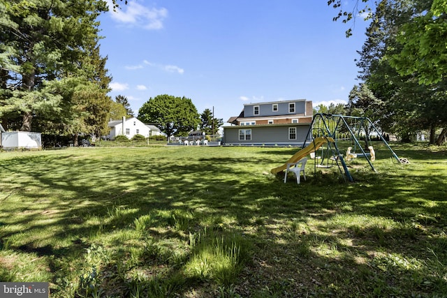view of yard with fence and a playground