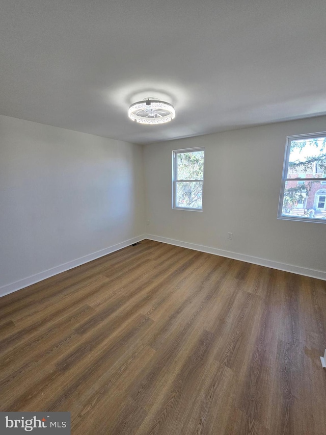 1055 E Cheltenham Ave, Philadelphia, PA 19124 - empty room featuring baseboards and dark wood-style flooring