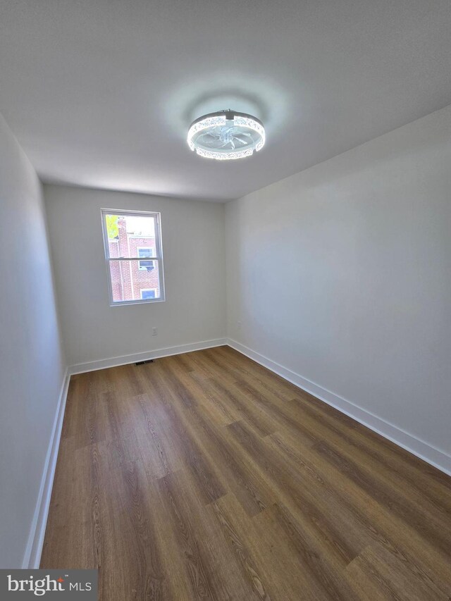 1055 E Cheltenham Ave, Philadelphia, PA 19124 - empty room with baseboards and dark wood-style floors
