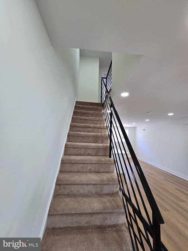 1055 E Cheltenham Ave, Philadelphia, PA 19124 - stairs with wood finished floors, baseboards, and recessed lighting